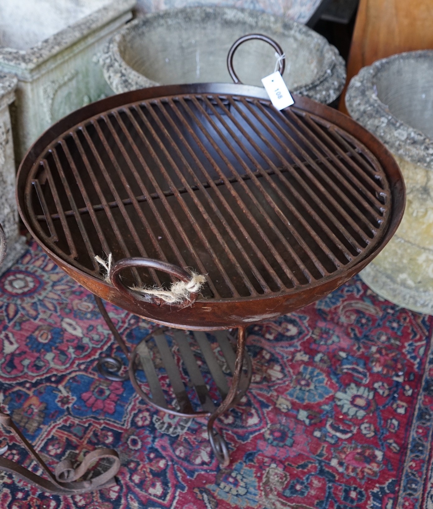 A wrought and cast iron fire pit on stand, diameter 62cm, height 65cm